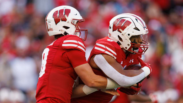 Oct 14, 2023; Madison, Wisconsin, USA; Wisconsin Badgers quarterback Braedyn Locke (18) hands the football off to running back Braelon Allen (0) during the third quarter against the Iowa Hawkeyes at Camp Randall Stadium. Mandatory Credit: Jeff Hanisch-USA TODAY Sports